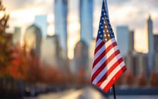 Health Effects Arising from the September 11th Attacks portrayed by downtown Manhattan and the American flag in the foreground with the twin towers in the background.